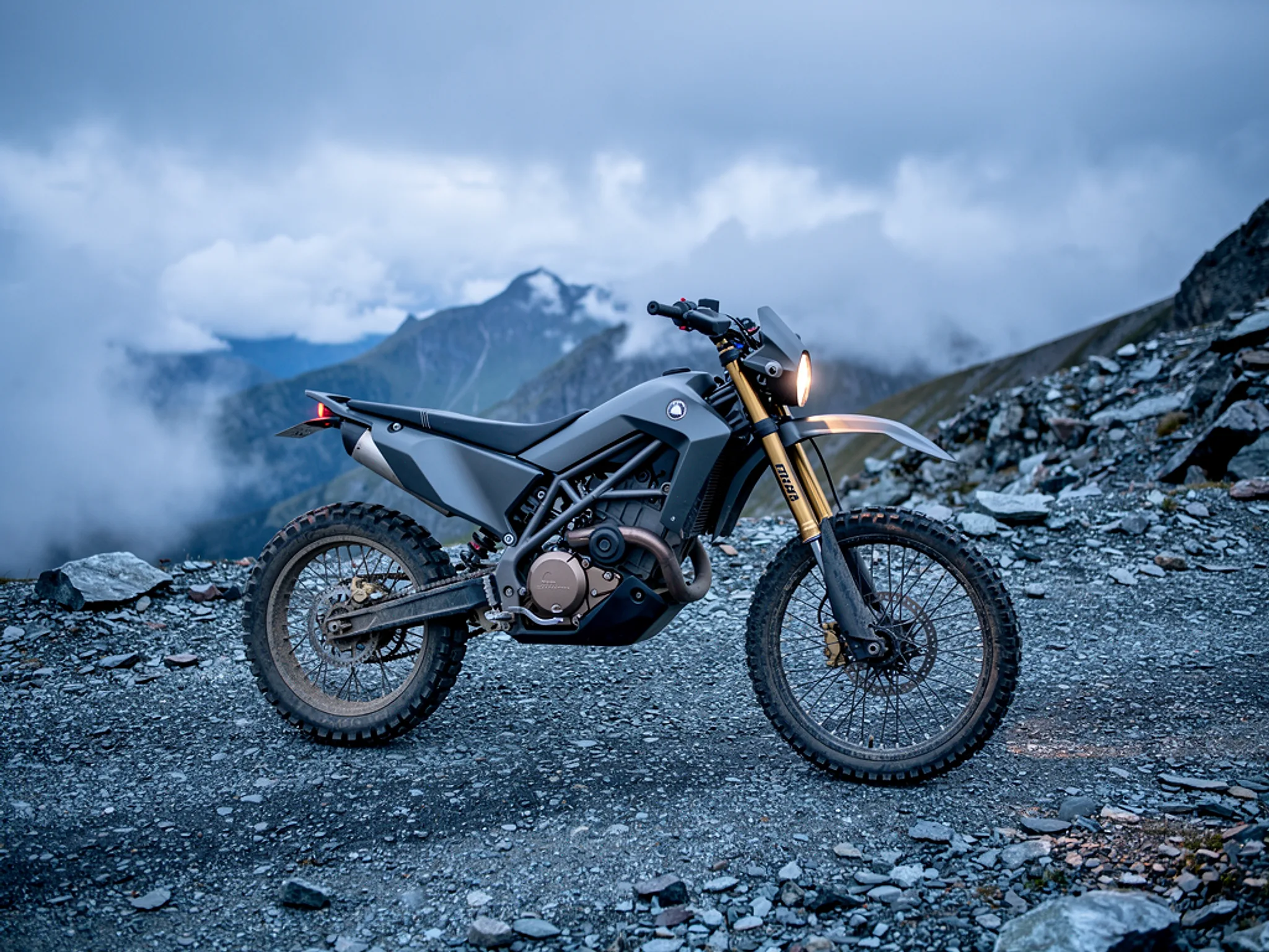 Ridge Runner: Electric enduro motorcycle on a gravel mountain pass.